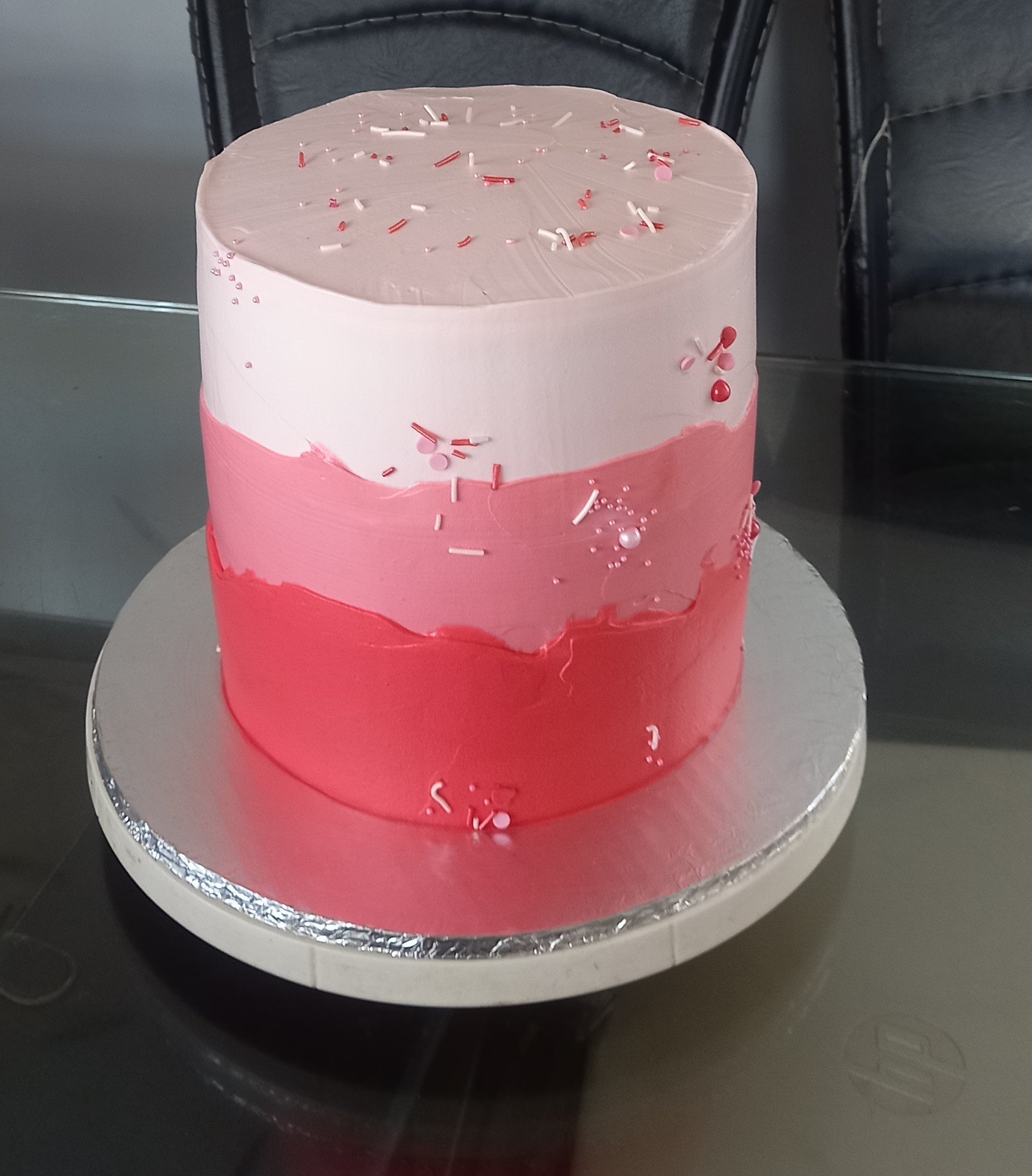 Tall pink ombre buttercream cake with sprinkles
