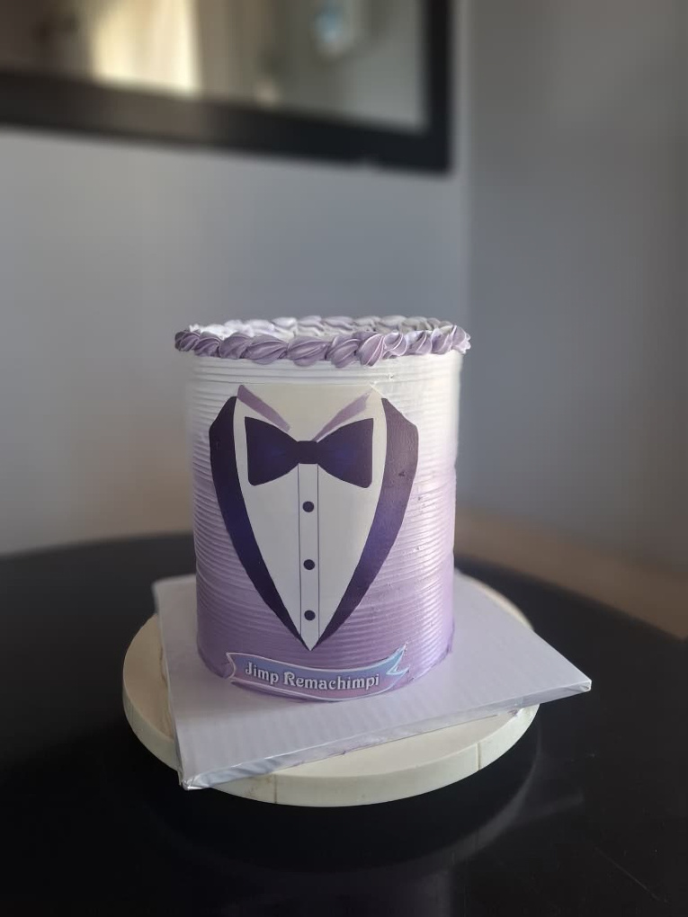 Purple tuxedo cake with edible bow tie design